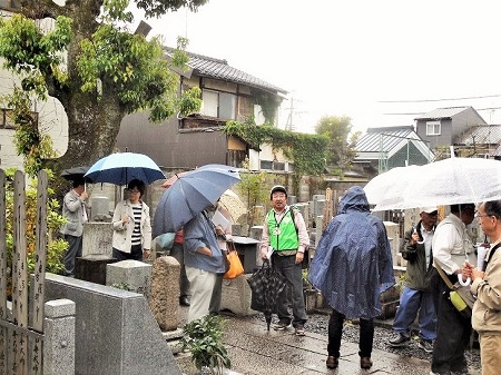 大黒寺墓地で薩摩九烈士、平田靭負及び八代美津女の墓ついて説明 (森幸弘部長)